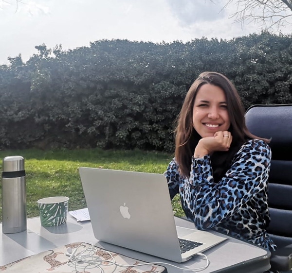 Magdalena sitting at her computer outside
